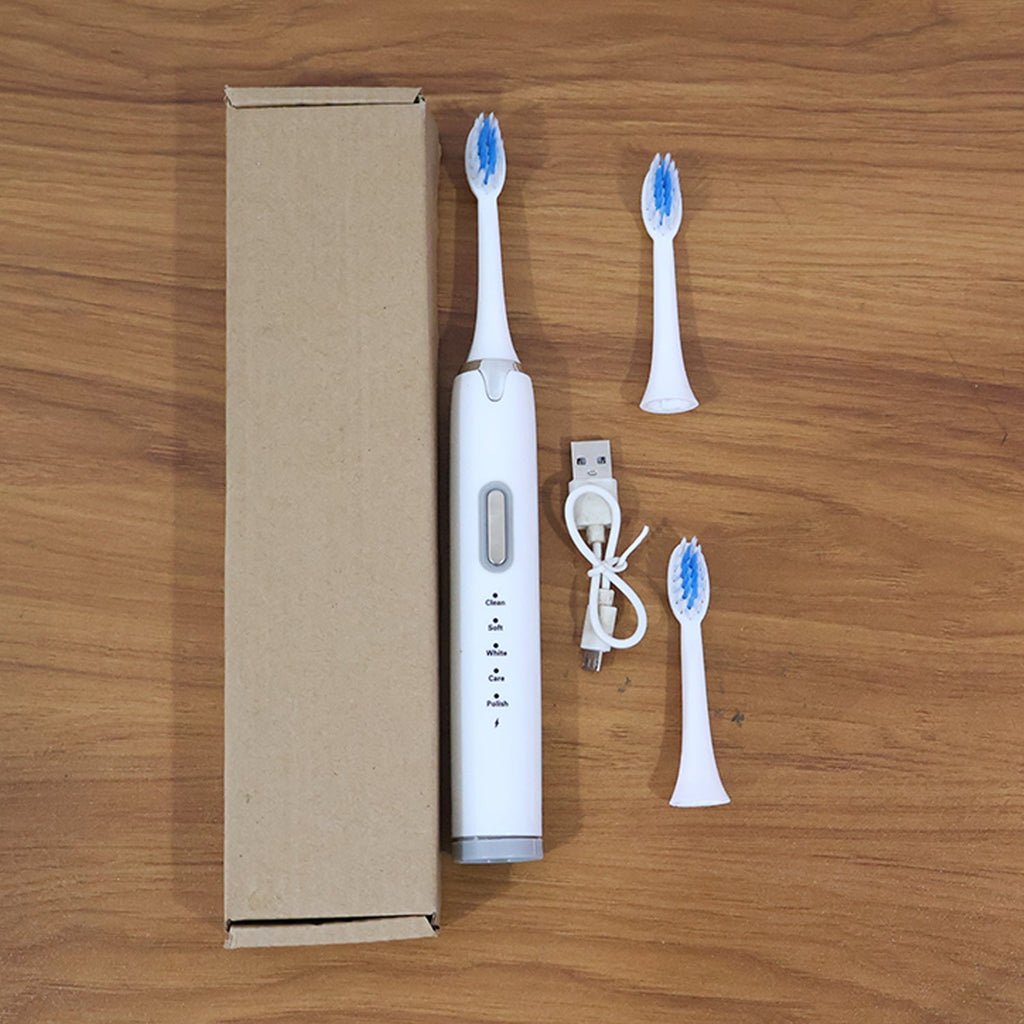 Complete electric toothbrush set in compact brown box packaging for gifting