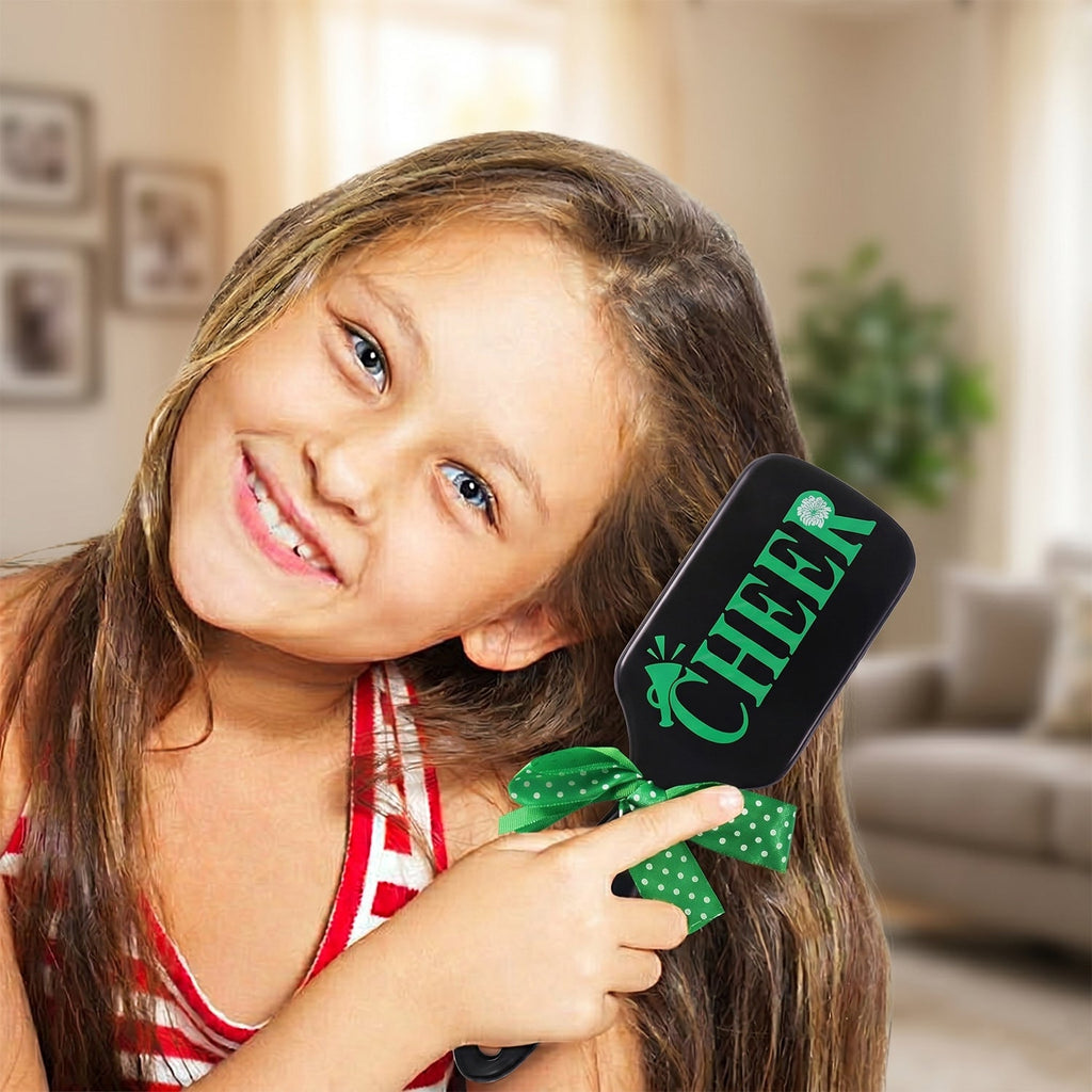 Children's hair styling brush with soft bristles and playful printed design.