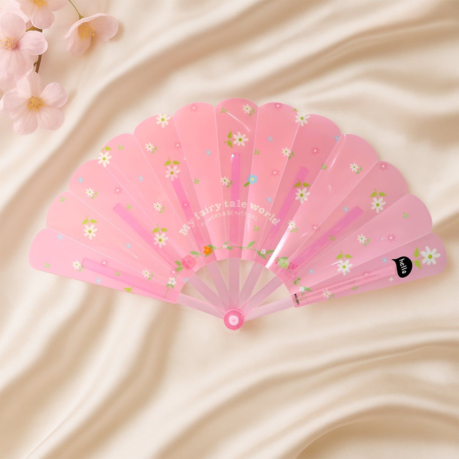 Foldable floral hand fan resting elegantly on table