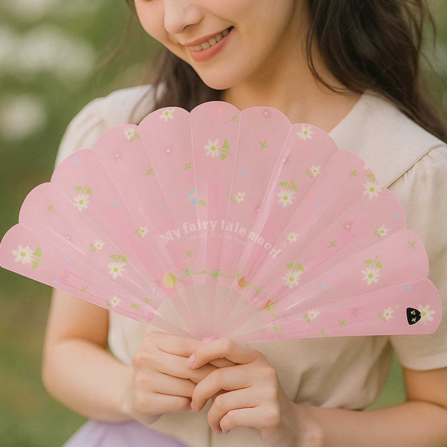 Side profile of floral foldable hand fan revealing design detail