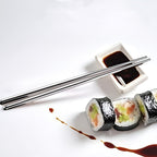 Reusable stainless steel chopsticks neatly placed on a chopstick rest.