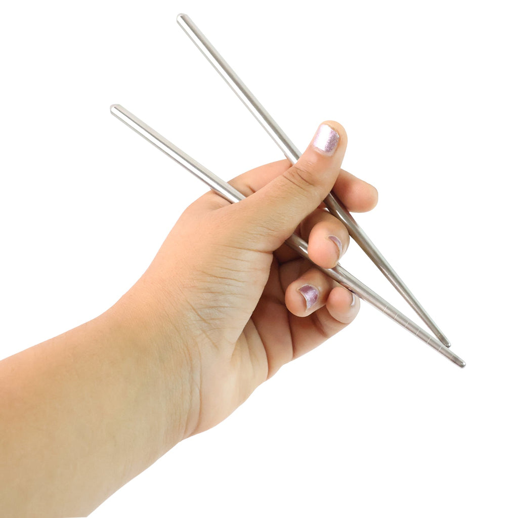 A pair of polished stainless steel chopsticks isolated on a white background.