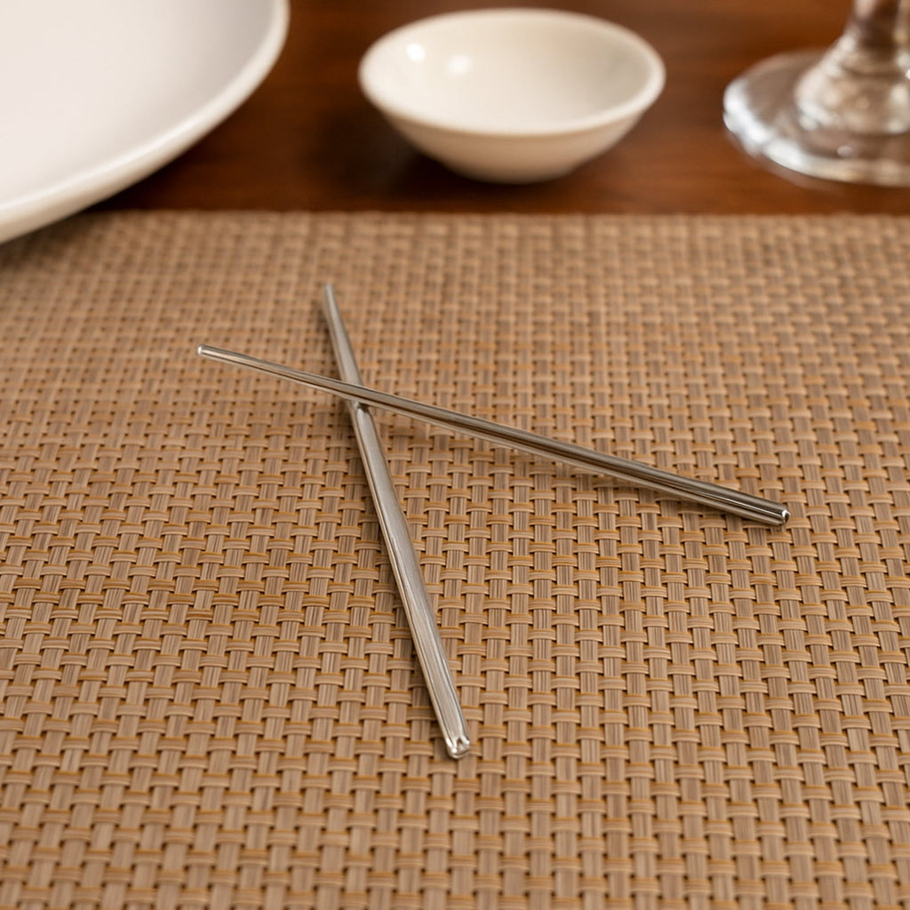 Detailed close-up of the textured tips of stainless steel chopsticks.