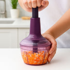 Side view of manual push vegetable chopper with stainless steel blades and clear container