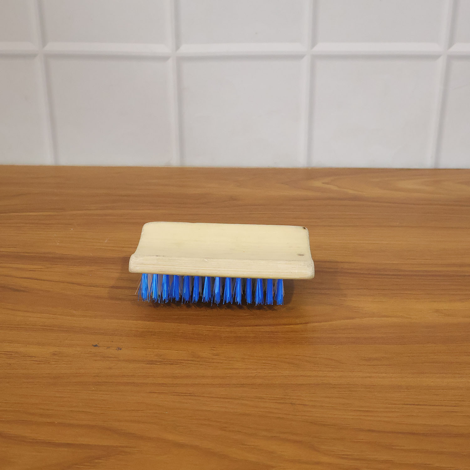 Cleaning brush with hard bristles in use for general household cleaning tasks