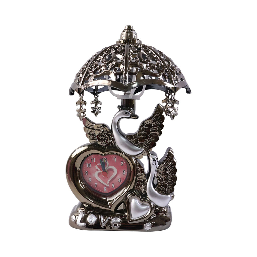 Ornamental heart-shaped analog clock on decorative table lamp
