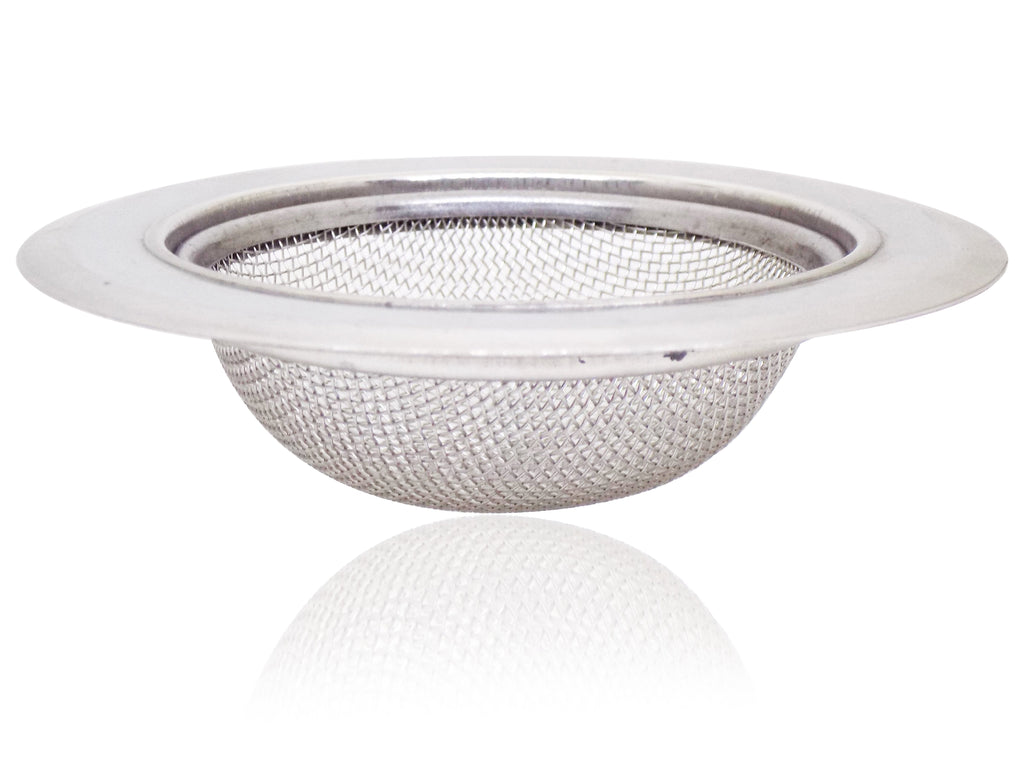Stainless steel sink strainer seamlessly installed in a modern kitchen basin.