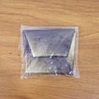 Coin pouch folded compactly, ready to carry