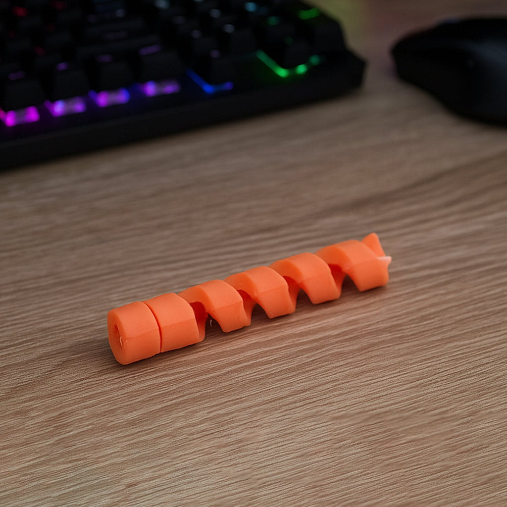 Close-up of a spiral cable protector installed on a black wire.