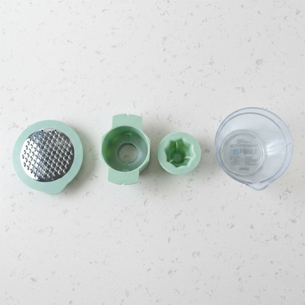 Top-down view showing various grating surfaces on manual vegetable grater