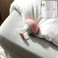 Soft Duvet Button Clip securely attached on bed comforter