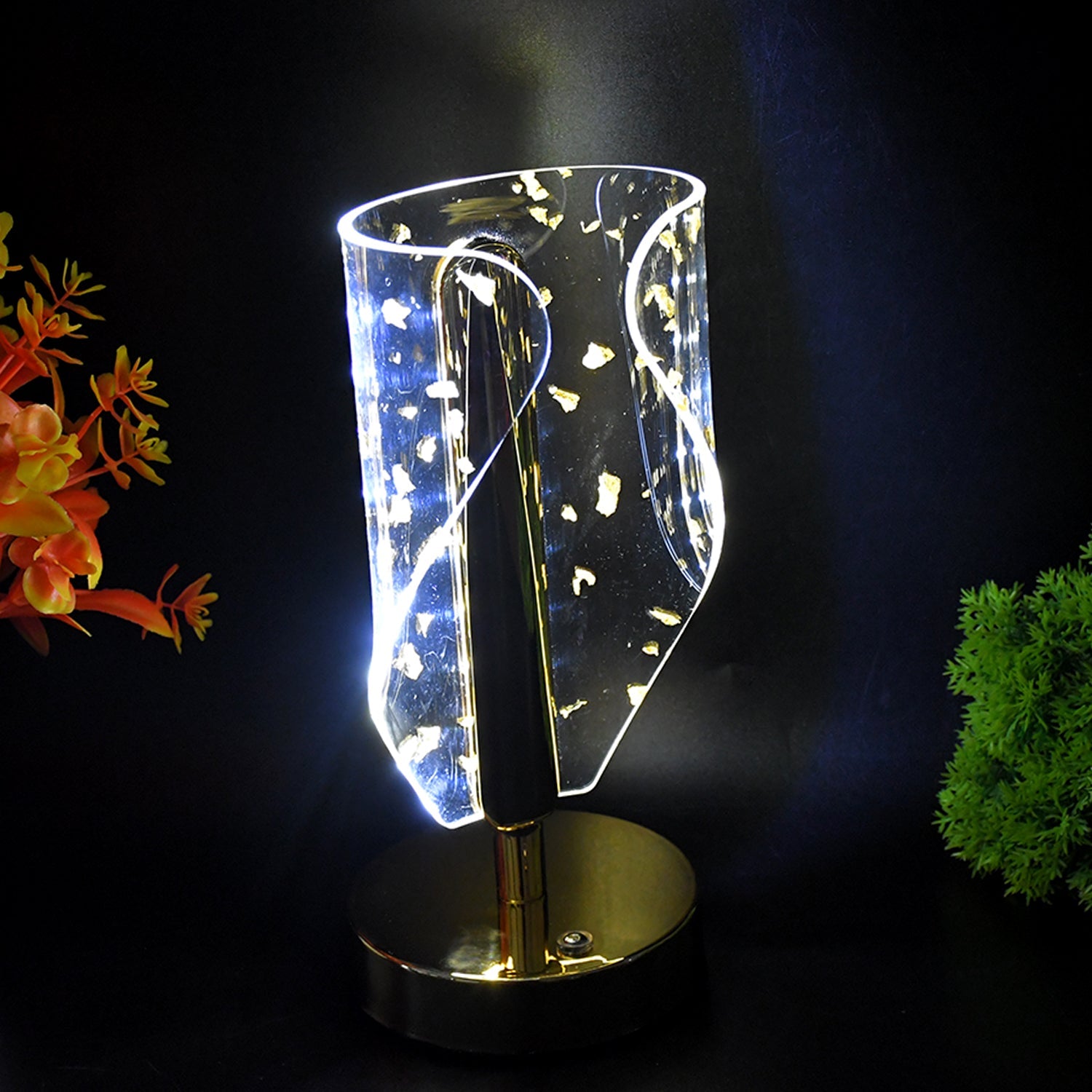 Close-up of crystal acrylic shade with golden leaf patterns on table lamp