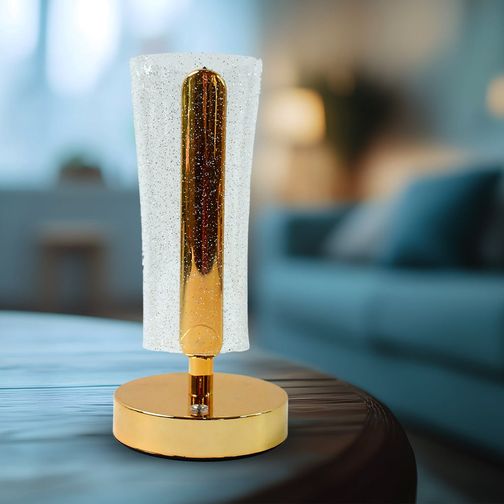 Close-up of golden base and acrylic crystal sparkle shade table lamp
