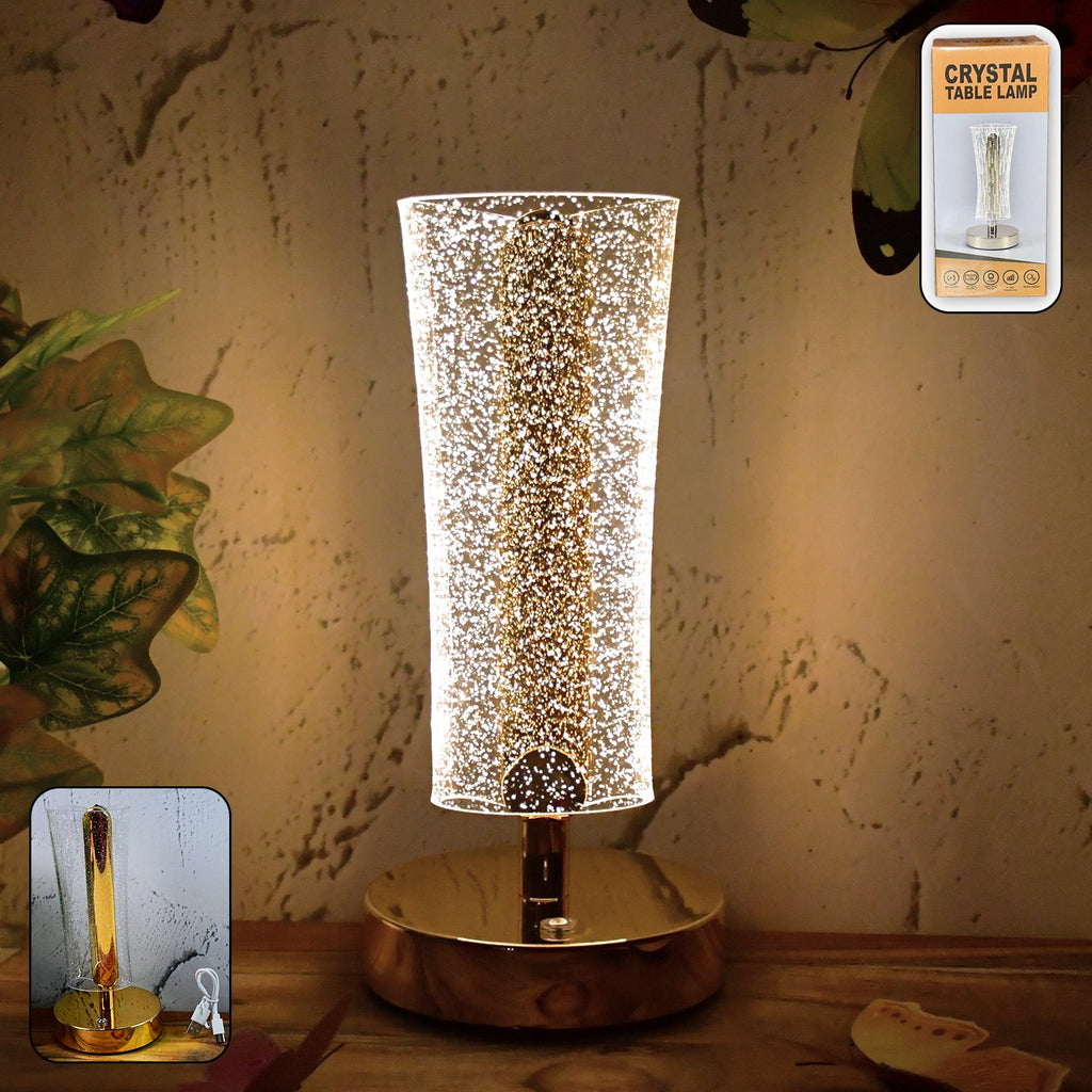 Crystal table lamp with sparkle acrylic shade and golden base illuminating softly