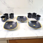 Elegant seashell ceramic cup set with matching plastic bowls arranged for serving.