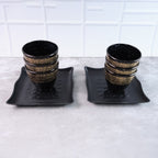 Artfully arranged ceramic dining set with six cups and two bowls, ready for use.
