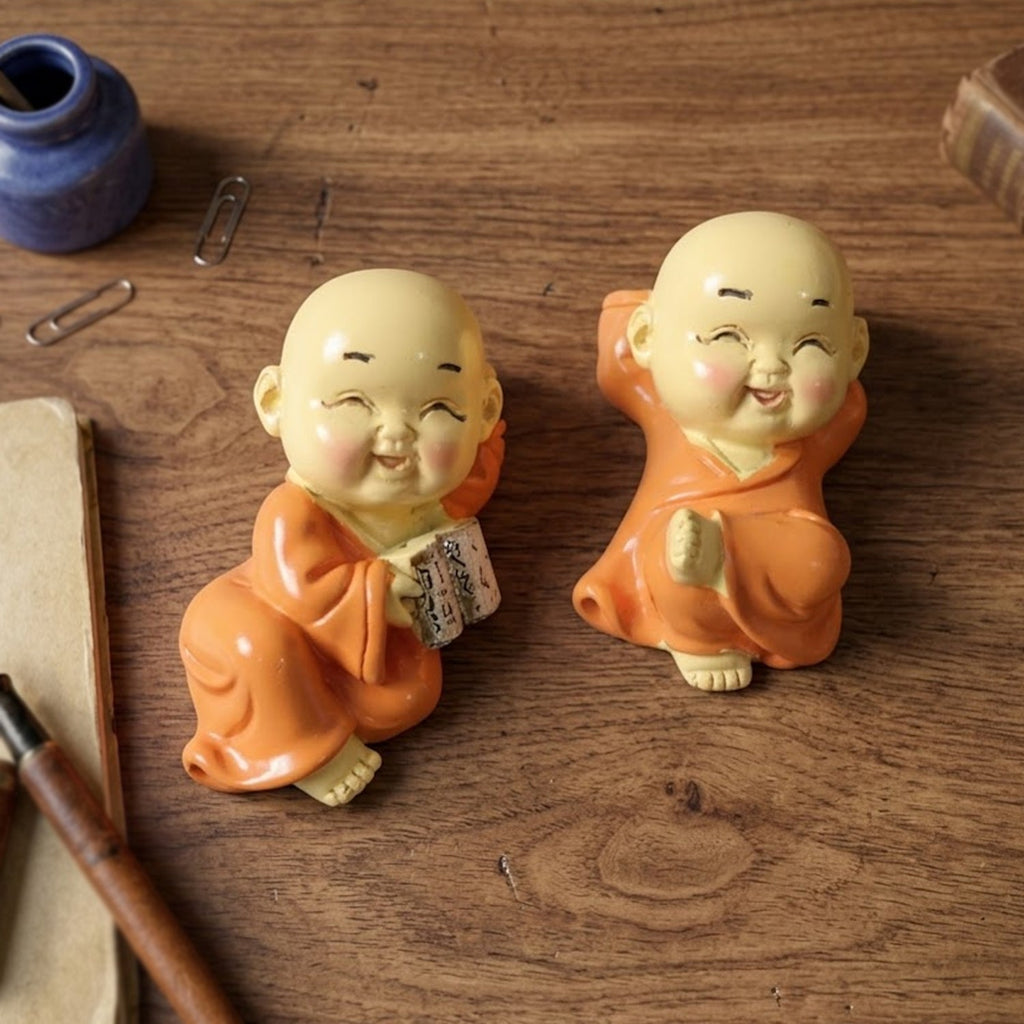 Decorative Mini Monk Buddha idols with joyful expressions displayed on shelf