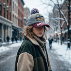 Close-up of winter woolen cap with pom pom showcasing soft knit fabric