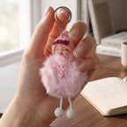 Plush doll keychain clipped on a bag zipper with visible lightweight design