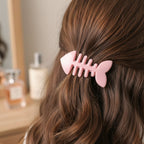 Close-up of pink flower cartoon hair clip showcasing snap mechanism.
