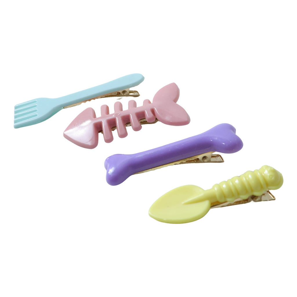Four different cartoon hair clips neatly arranged to add fun to any hairstyle.