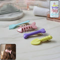 Set of four colourful cartoon hair clips for girls with animal and fruit designs.