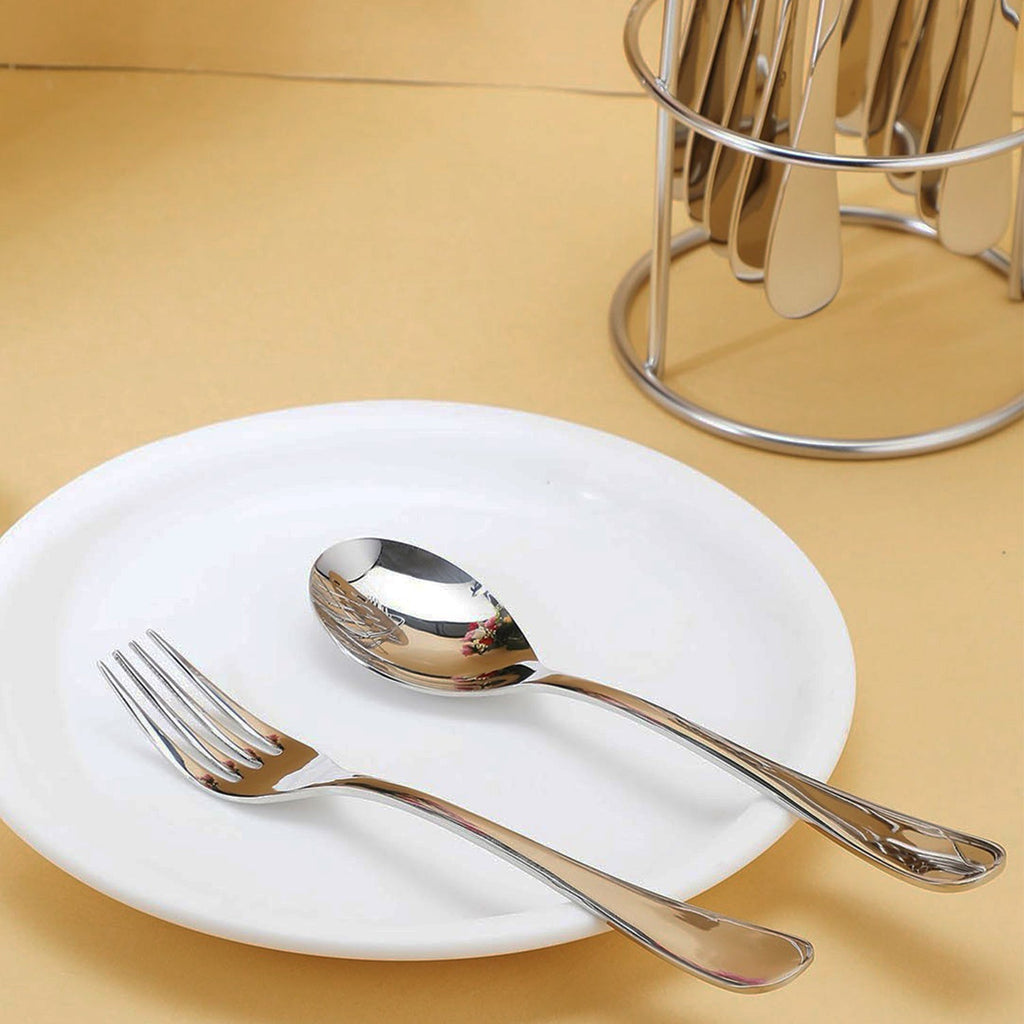 Utensils of stainless steel cutlery set neatly arranged on table