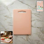 Plastic chopping board with handle grip on kitchen counter