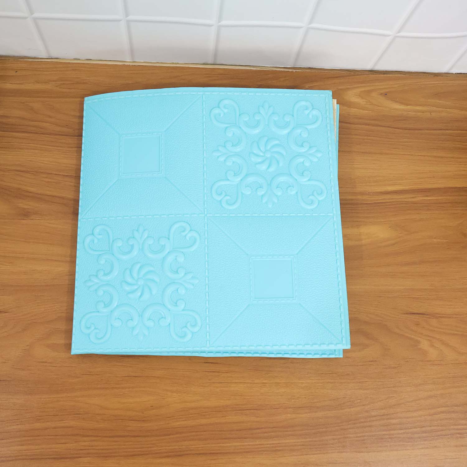 Living room wall decorated with 3D foam wallpaper panels in cyan