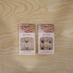 Model displaying burgundy floral artificial press-on nails with a fashionable outfit
