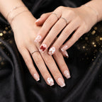 Close-up of glitter 3D floral press-on nails highlighting intricate petal and crystal embellishments.