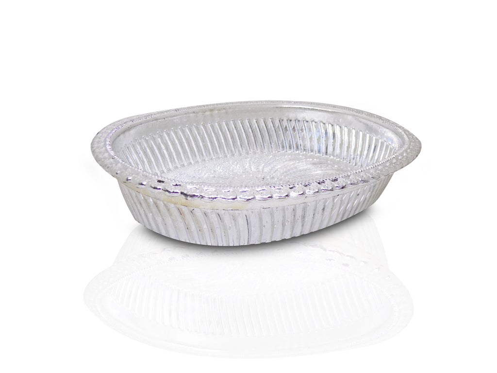 Close-up of a decorative oval silver tray with intricate royal patterns.