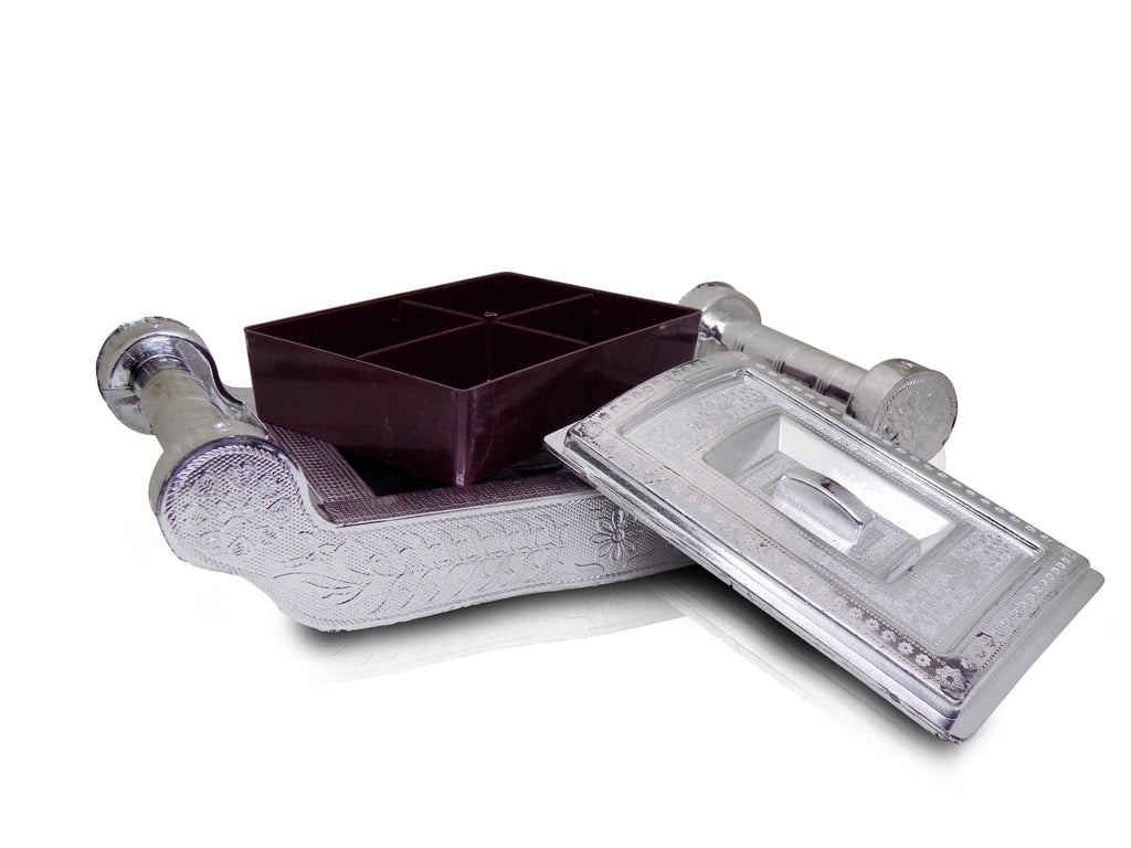 Decorative silver storage box with intricate patterns for organizing treats.