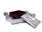 Decorative silver storage box with intricate patterns for organizing treats.