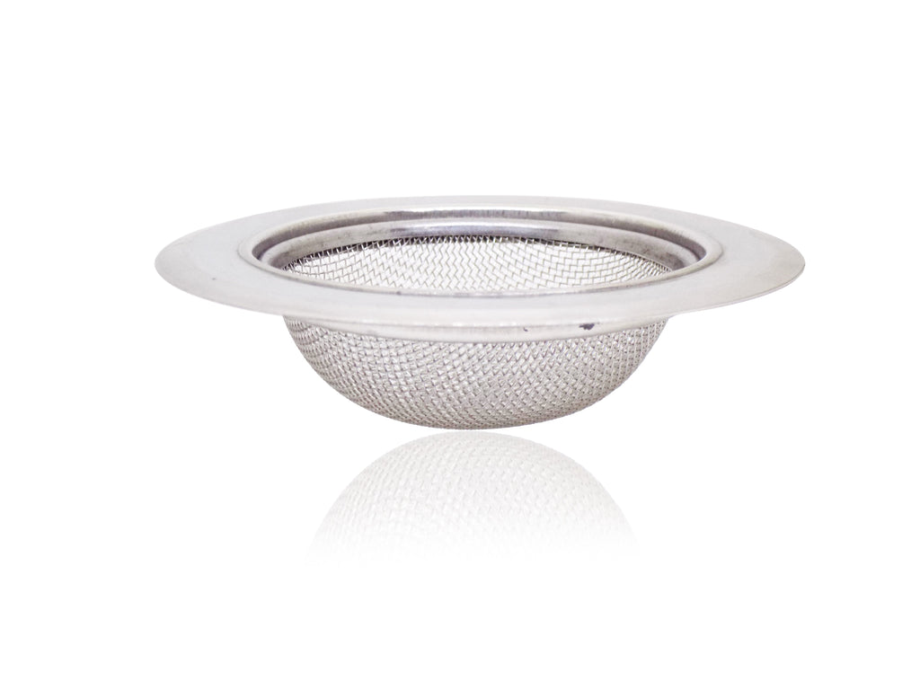 Stainless steel sink strainer effectively catching food particles in a kitchen wash basin drain.