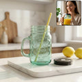 Clear glass Mason Jar with Handle and reusable BPA-free straw.