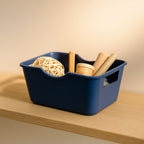 Compact utility basket organizer shown with handles for easy carrying