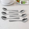 Set of six polished stainless steel dining spoons with elegant engraved handles