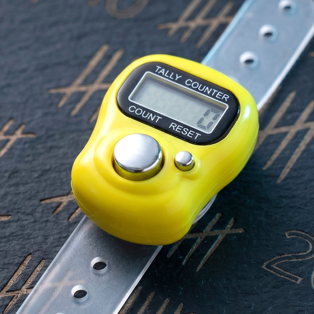 Digital finger tally counter held in hand for meditation and exercise counting