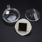 Diamond solar garden lights staked in a lush garden bed with green plants