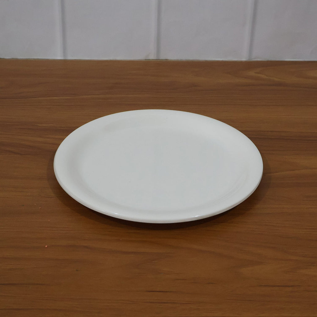 Plastic round dinner plate in use serving Indian meals