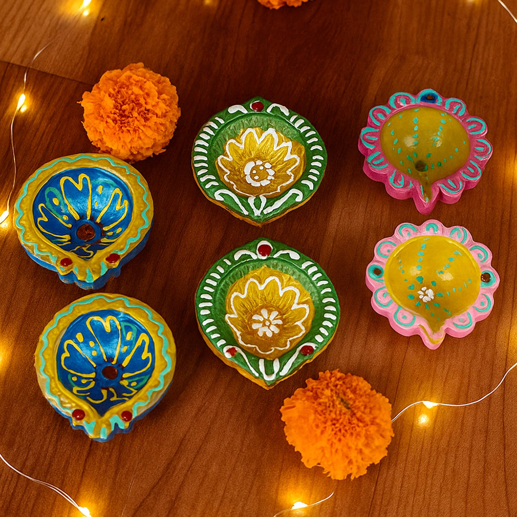 Collection of decorative clay diyas arranged for festival lighting