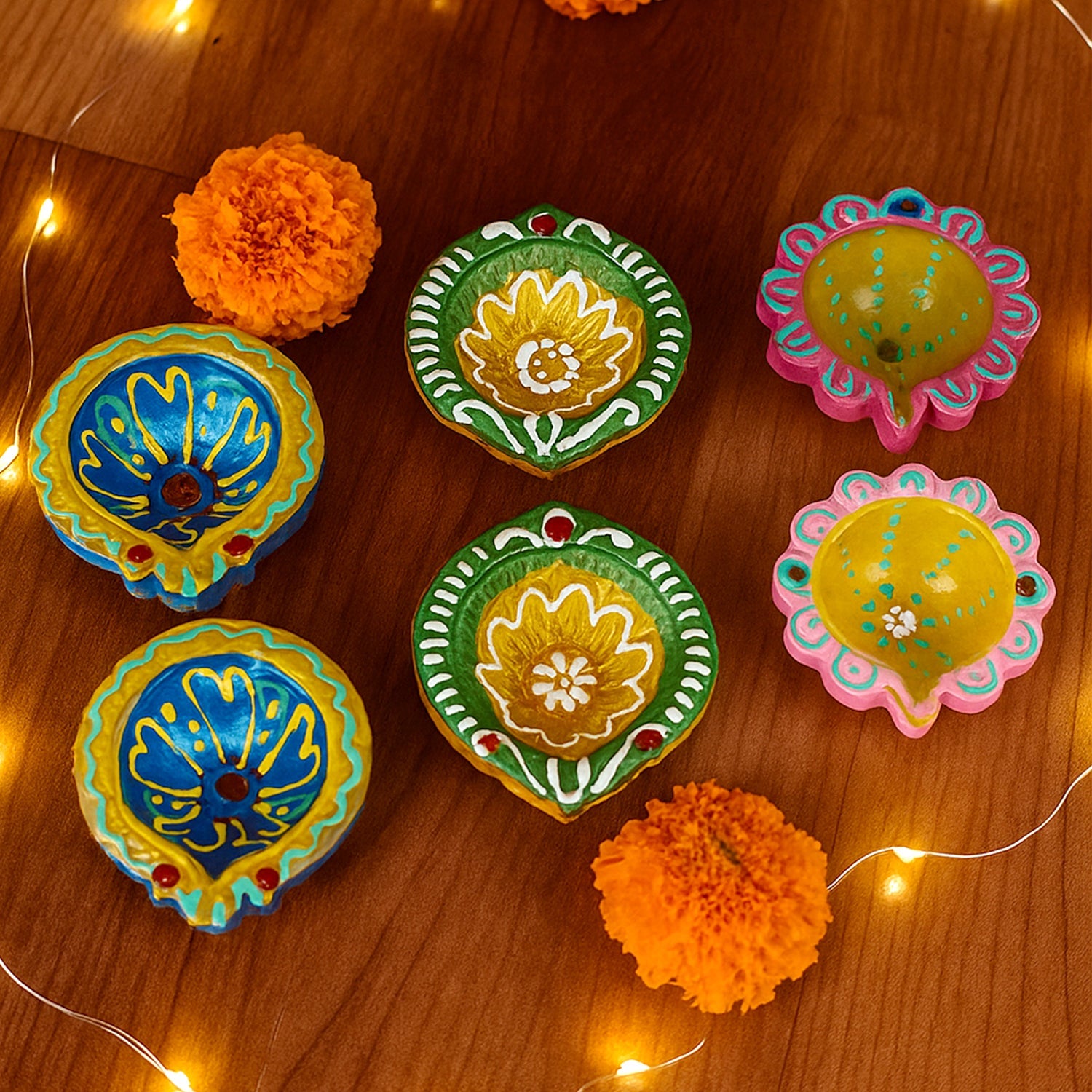 Collection of decorative clay diyas arranged for festival lighting