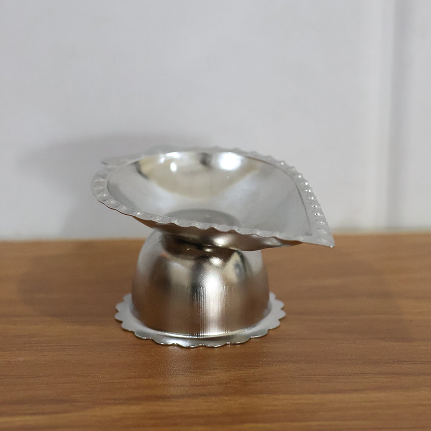 Aromatic incense and diya shown on elegant stainless steel stand