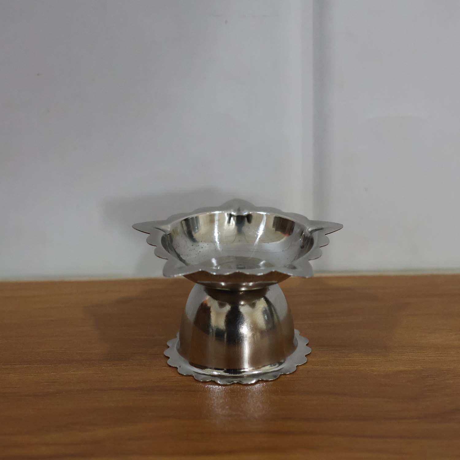 Silver-toned stainless steel sunflower diya for pooja and aarti rituals