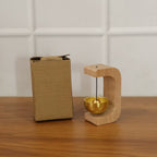Zen meditation bell positioned on stand bathed in natural light