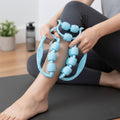 Person using double wheel muscle massager on leg for deep tissue relief