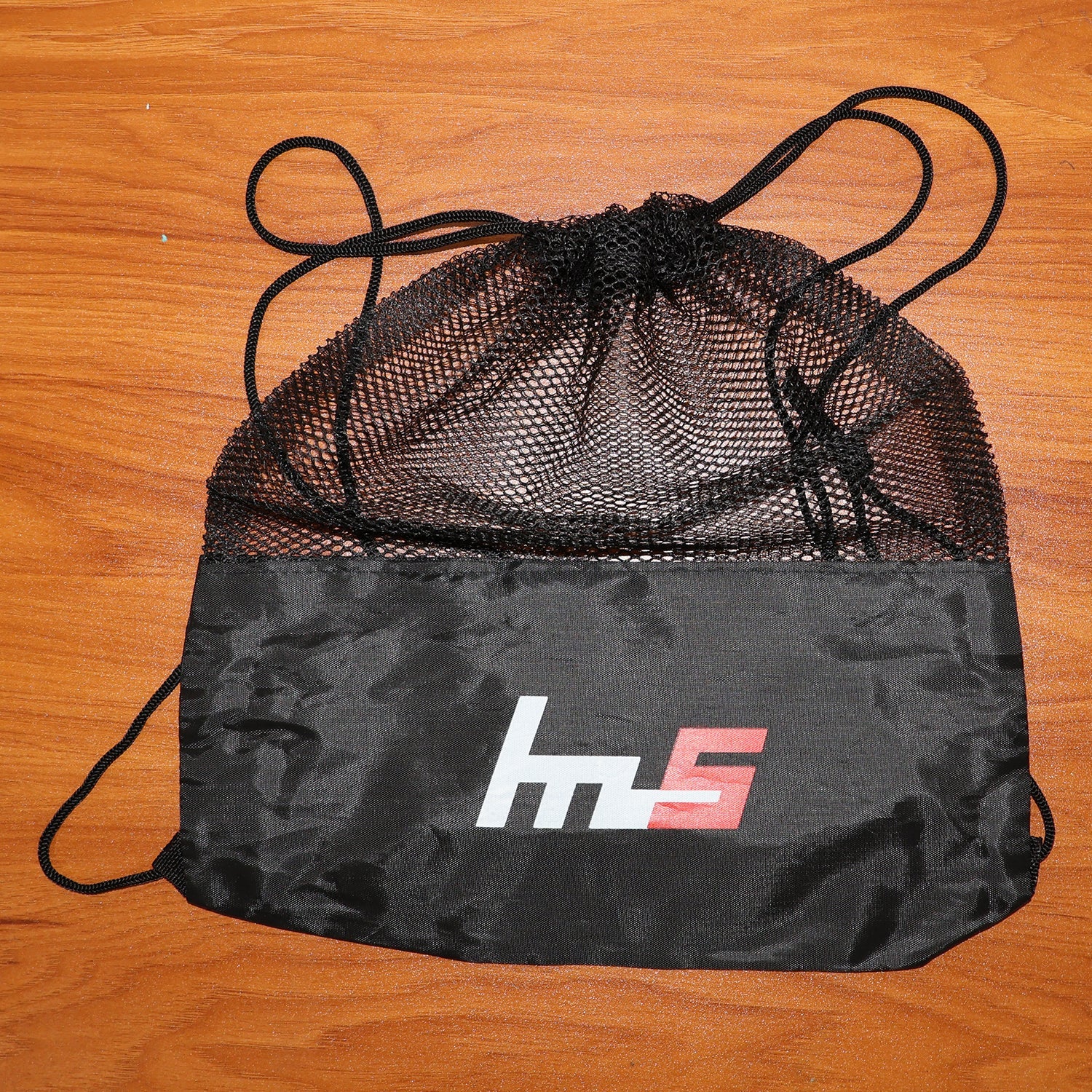Mesh drawstring gym sack displayed flat, highlighting its lightweight design.