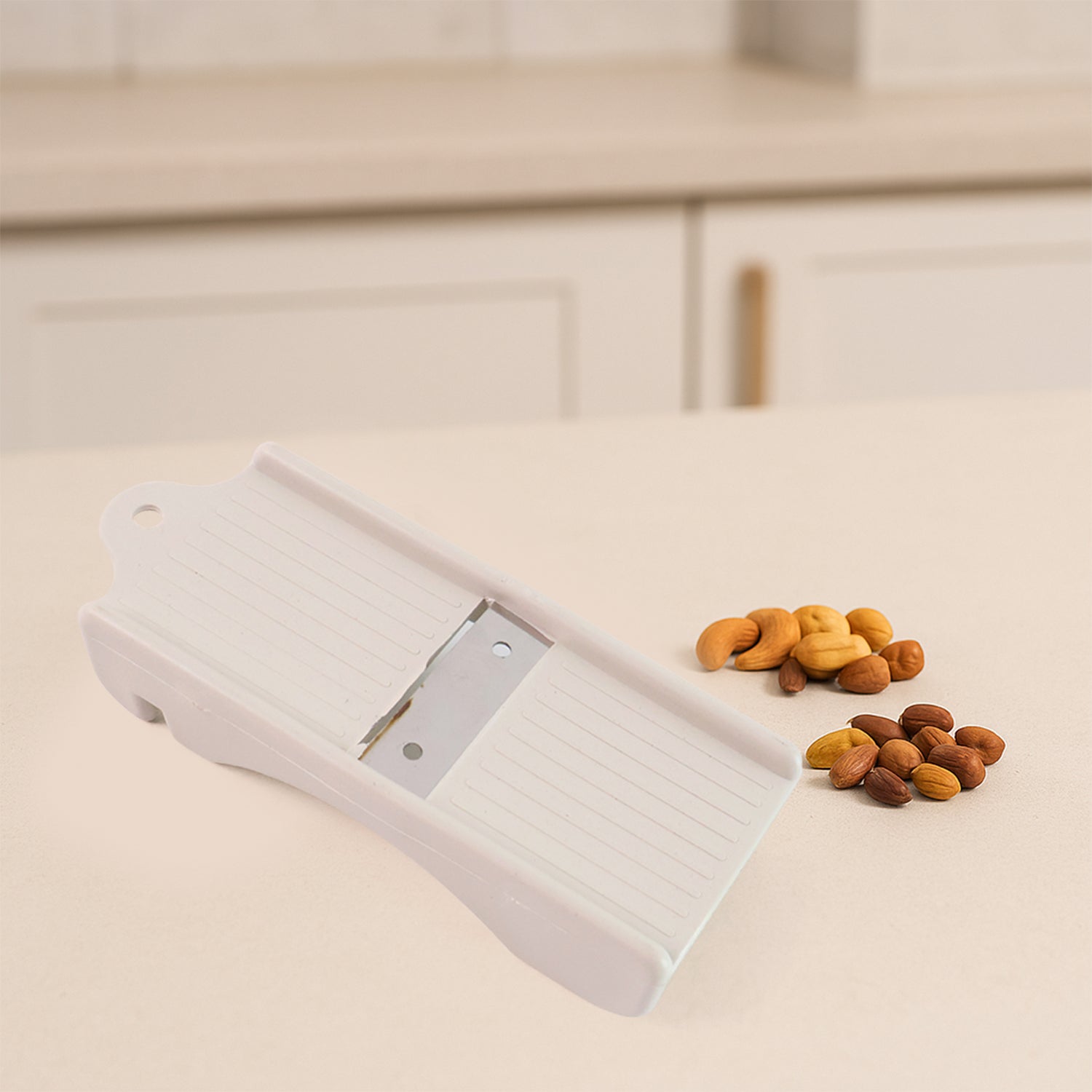 Dry fruit slicer showing slicing action on cashews and ginger