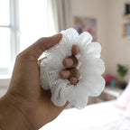 White mesh hair scrunchie adding volume and texture to styled hair